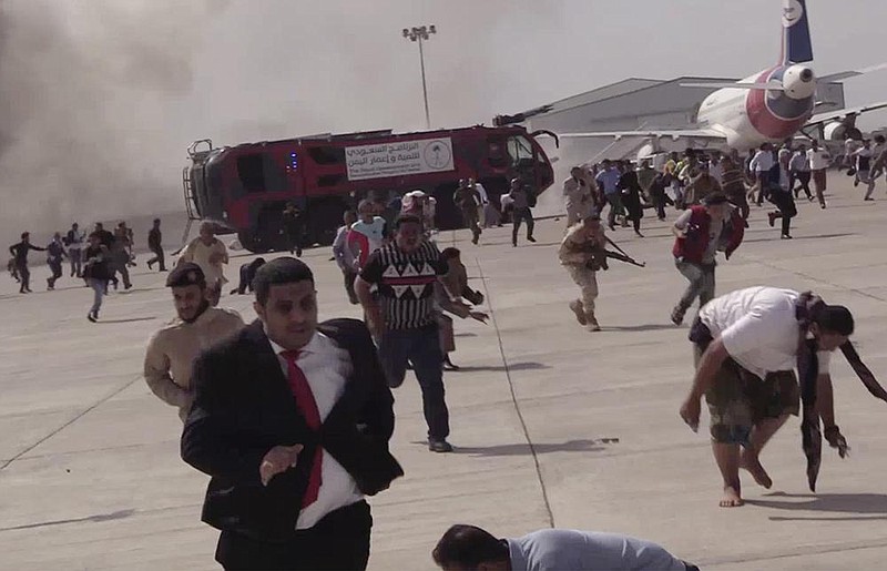 An explosion sends people running Wednesday at the airport in Aden, Yemen, shortly after a plane carrying Yemen’s newly formed Cabinet landed. No one on board the plane was hurt, but at least 22 people were killed and 50 wounded at the airport. Later, an explosion went off near the palace where Cabinet members were staying, and a bomb-laden drone reportedly was shot down nearby.
(AP)