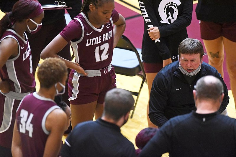 UALR Coach Joe Foley (right) talks with his team during a timeout against Arkansas earlier this month. Foley said the Sun Belt Conference’s new schedule plan benefits teams in dealing with covid-19 but otherwise, “it’s not the best by any means.”
(Arkansas Democrat-Gazette/Staci Vandagriff)