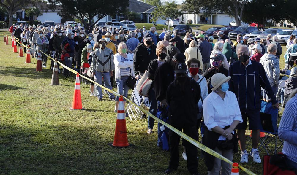Residents of Cape Coral, Fla., wait to receive covid-19 vaccinations Wednesday morning at a city park theater. The Florida Department of Health in Lee County is offering the vaccine to high-risk front-line health care workers and people age 65 and older.
(AP/The News-Press/Ricardo Rolon)