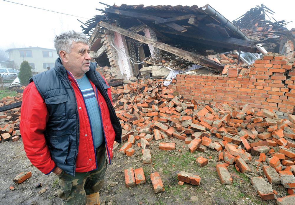 A man stands in front of a collapsed house Wednesday in Majska Poljana, Croatia, after a series of tremors, a day after a 6.3-magnitude earthquake.
(AP)