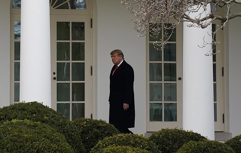 President Donald Trump arrives Thursday at the White House after cutting his holiday vacation short. More photos at arkansasonline.com/11trumps/.
(AP/Evan Vucci)