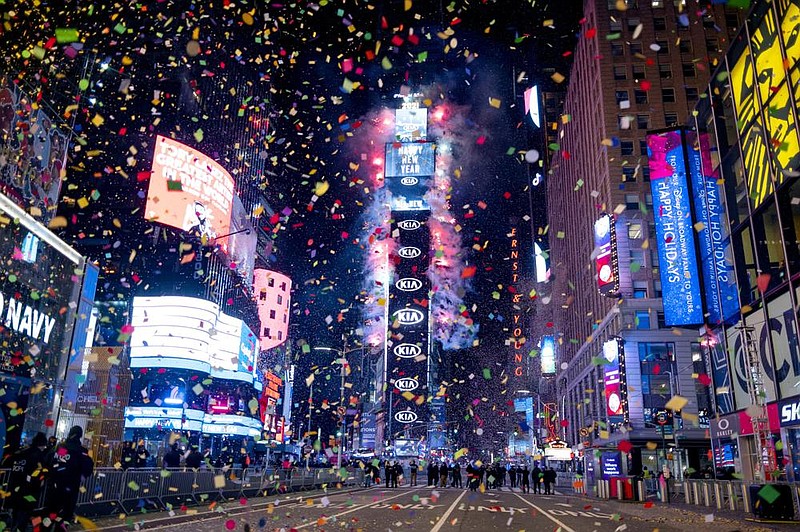 Confetti flies in a mostly empty Times Square in New York City early today as the crystal ball drops signifying the dawn of 2021. The square, normally packed with revelers, was closed this year because of the coronavirus pandemic. More photos at arkansasonline.com/11nye20/.
(AP/Craig Ruttle)