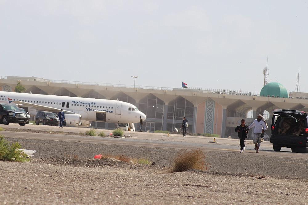 People walk away from the runway Wednesday after an explosion at the airport in Aden, Yemen. The explosion occurred as Cabinet members were disembarking from a plane.
(AP/Wael Qubady)