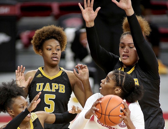 Members of the University of Arkansas at Pine Bluff Golden Lions play against Taylah Thomas and the rest of the University of Arkansas, Fayetteville women's basketball team in Bud Walton Arena at the campus in Fayetteville in this Dec. 21, 2020, file photo.