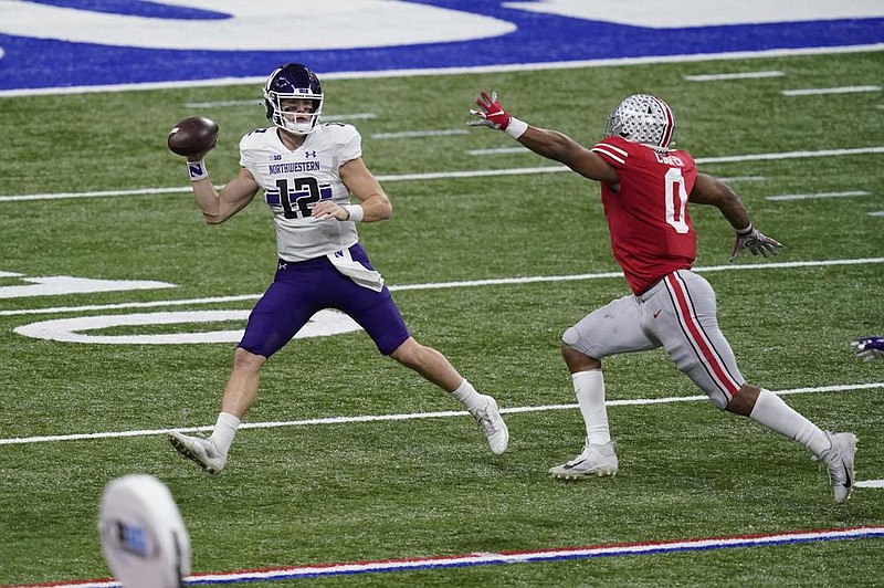 Peyton Ramsey (12) threw three touchdown passes and ran for a score, and 14th-ranked Northwestern clamped down defensively to beat Auburn 35-19. Ramsey, a graduate transfer, totaled 291 yards passing and 50 yards rushing for the Wildcats (7-2), who won their fourth consecutive bowl game.  More photos at arkansasonline.com/12citrusbowl/
(AP/Darron Cummings)