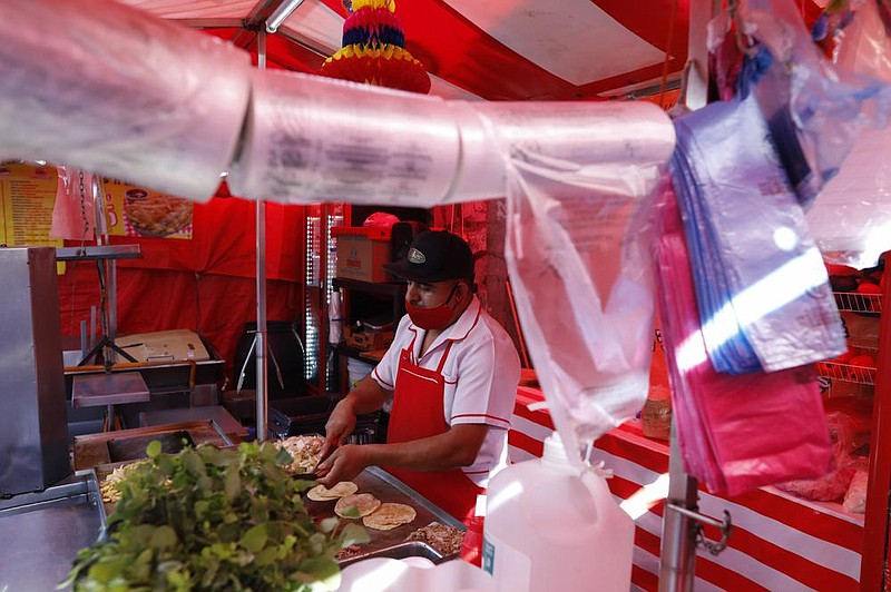 Biodegradable plastic bags hang Friday at a taco stand in central Mexico City.
(AP/Rebecca Blackwell)