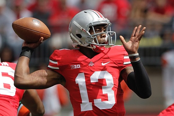 Ohio State quarterback Kenny Guiton looks for a receiver against Florida A&M during an NCAA college football game Saturday, Sept. 21, 2013, in Columbus, Ohio. (AP Photo/Jay LaPrete)