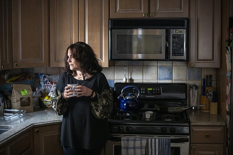 Michele Miller stands in her New York home recently. She developed anosmia after a bout with covid-19 in March and did not smell the gas from the oven filling up her kitchen.
(The New York Times/Joshua Bright)