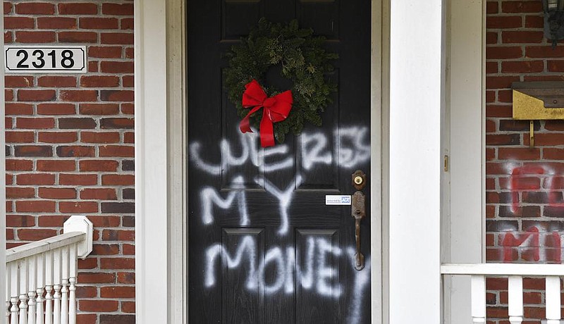 Graffiti reading “where’s my money” is painted on a door Saturday at the Louisville, Ky., home of Senate Majority Leader Mitch McConnell.
(AP/Timothy D. Easley)