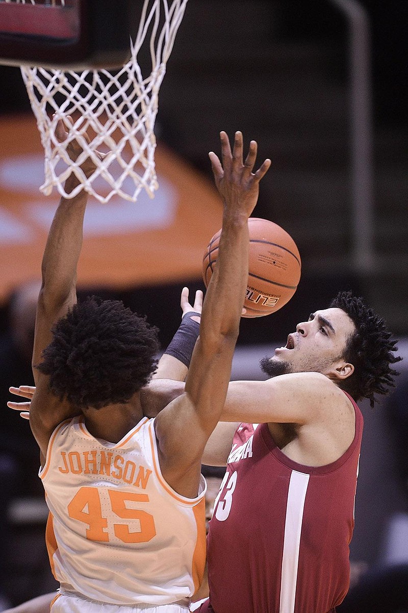 Alabama's Jahvon Quinerly (13) attempts to shoot against Tennessee's Keon Johnson (45) during an NCAA college basketball game Saturday, Jan. 2, 2021, in Knoxville, Tenn. (Caitie McMekin/Knoxville News Sentinel via AP, Pool)