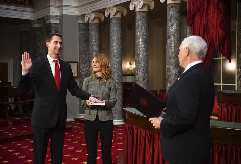 Vice President Mike Pence administers the oath of office to U.S. Sen. Tom Cotton, R-Ark., as his wife Anna Peckham holds a Bible during a reenactment ceremony in the Old Senate Chamber at the Capitol in Washington on Sunday, Jan. 3, 2021. (Kevin Dietsch/Pool via AP)