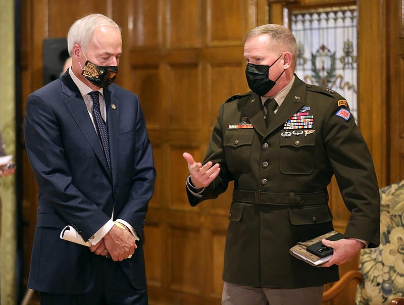 Gov. Asa Hutchinson (left) speaks with Major General Kendall Penn, Adjutant General of the Arkansas National Guard after the weekly covid-19 press conference on Tuesday, Jan. 5, 2021, at the state Capitol in Little Rock. 
(Arkansas Democrat-Gazette/Thomas Metthe)