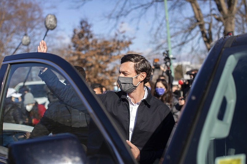 Democratic U.S. Senate challenger Jon Ossoff waves after speaking to the media at Dunbar Neighborhood Center during Georgia's Senate runoff elections, Tuesday, Jan. 5, 2021, in Atlanta. (AP Photo/Branden Camp)