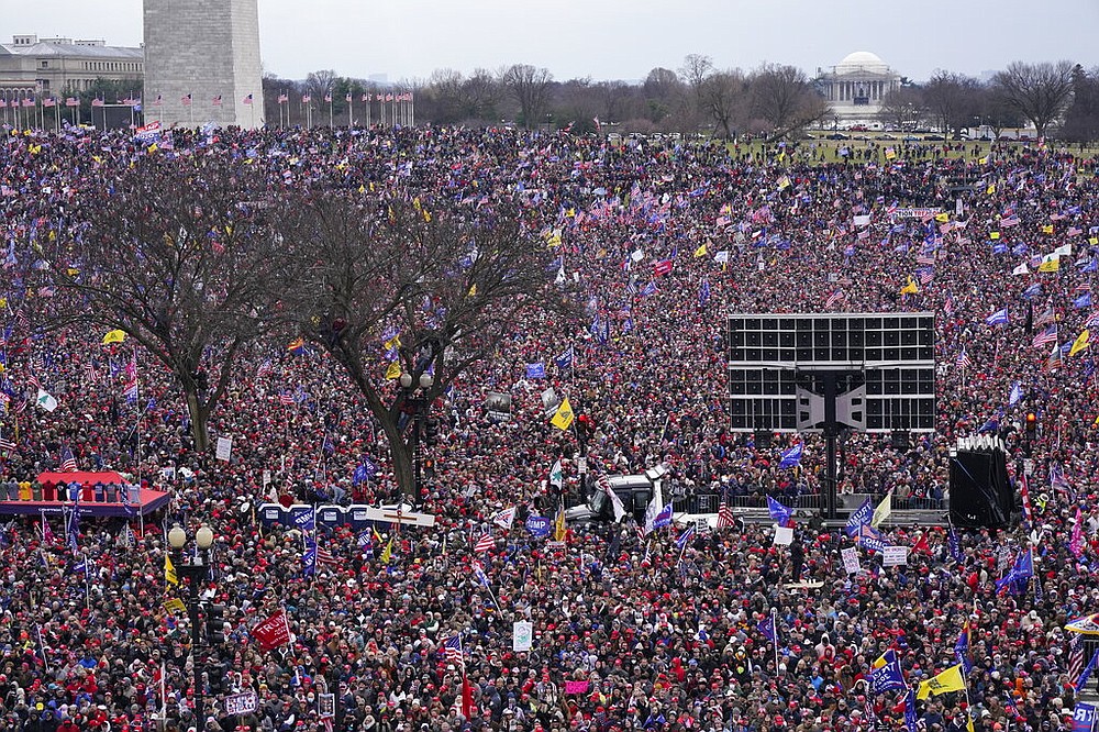 With the Washington Monument in the background, people attend a rally in support of President Donald Trump near the White House on Wednesday, Jan. 6, 2021, in Washington. (AP Photo/Jacquelyn Martin)
