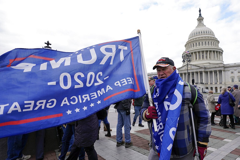 Supporters of President Donald Trump cary flags and banners on Capitol Hill during a rally, Wednesday, Jan. 6, 2021. in Washington. (AP Photo/Manuel Balce Ceneta)