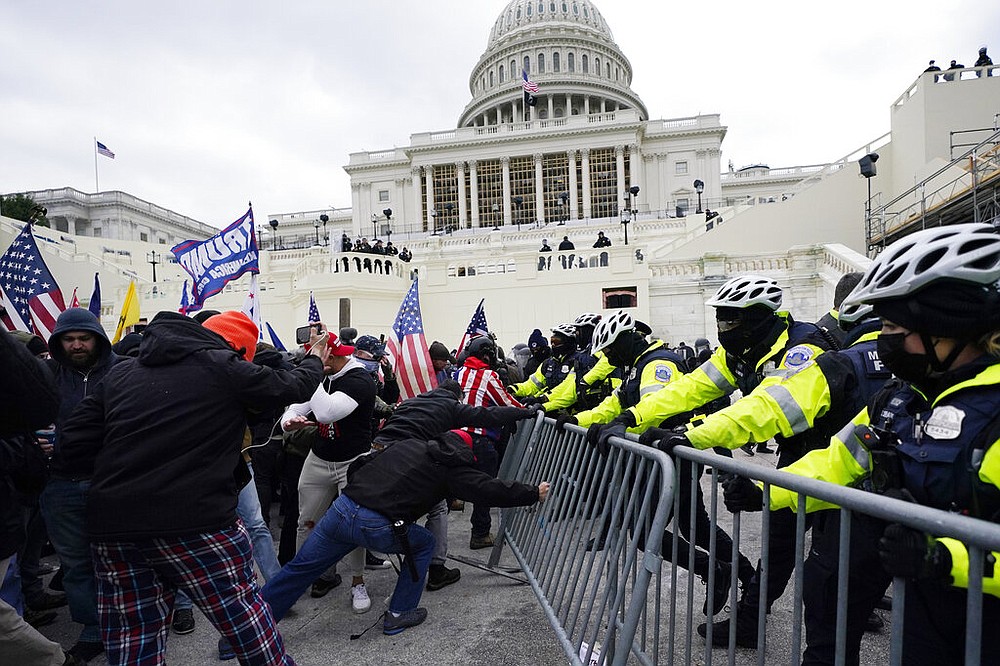 Trump supporters try to break through a police barrier, Wednesday, Jan. 6, 2021, at the Capitol in Washington.
