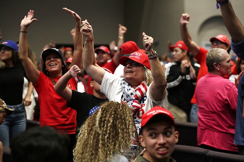Supporters of President Donald Trump, attending a rally at the King Jesus International Ministry in Miami, turn to jeer and give the news media thumbs-down in this Jan. 3, 2020, file photo. Trump has long had a bond with white evangelical voters.