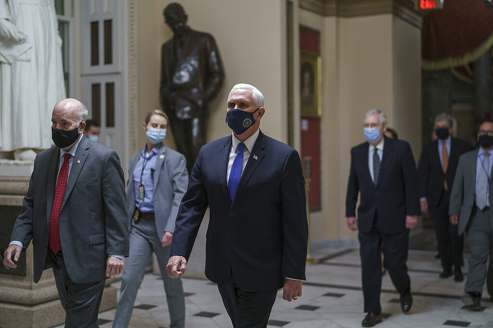 Vice President Mike Pence leads senators to the House chamber at the Capitol in Washington on Wednesday, Jan. 6, 2021.