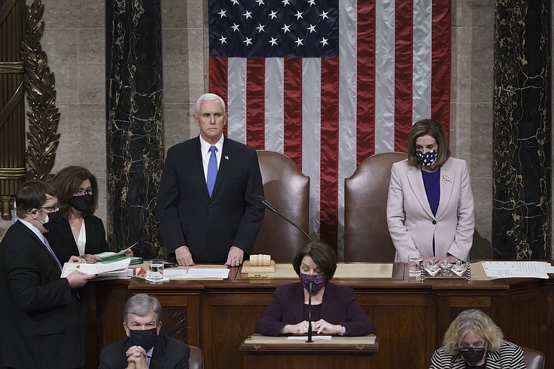 Vice President Mike Pence and Speaker of the House Nancy Pelosi, D-Calif., read the final certification of Electoral College votes cast in November's presidential election during a joint session of Congress after working through the night, at the Capitol in Washington, Thursday, Jan. 7, 2021. Violent protesters loyal to President Donald Trump stormed the Capitol Wednesday, disrupting the process. story.lead_photo.caption