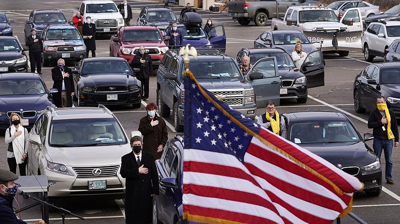 New Hampshire state representatives stand for the Pledge of Allegiance as an outdoor session of the state House of Representatives opens Wednesday in a parking lot at the University of New Hampshire in Durham.
(AP/Charles Krupa)