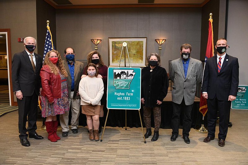 Gov. Asa Hutchinson (left) and other officials honor members of the Hughes Farm of Lincoln County at the Arkansas Century Farm Program induction ceremony Dec. 11. 
(Special to The Commercial)