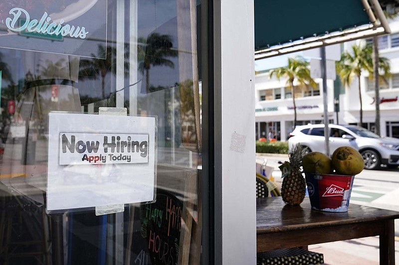 A “Now Hiring” sign sticks to the window of a restaurant Thursday in Miami Beach, Fla. The number of Americans seeking unemployment aid fell last week by 3,000 to 787,000.
(AP/Wilfredo Lee)