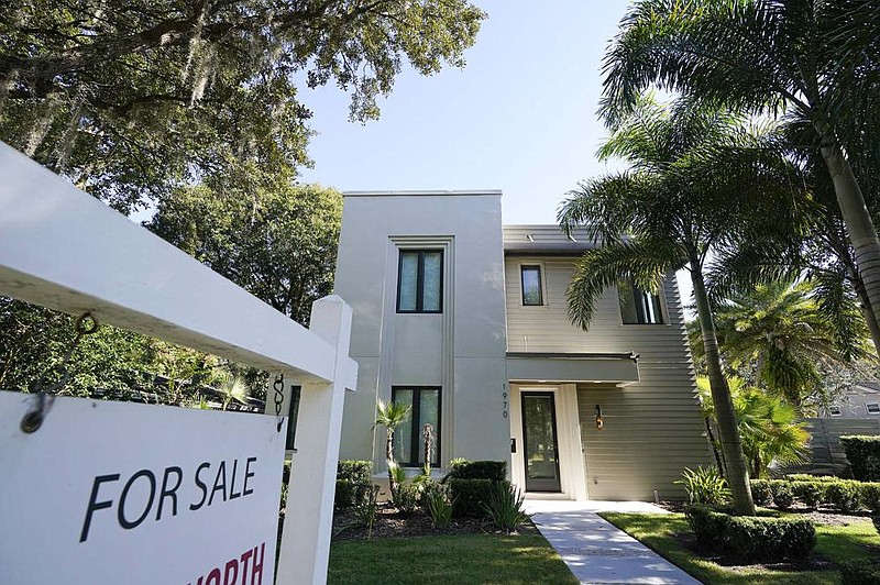 A home stands for sale in Orlando, Fla., in December. U.S. long-term mortgage rates dropped this week to new lows.
(AP/John Raoux)