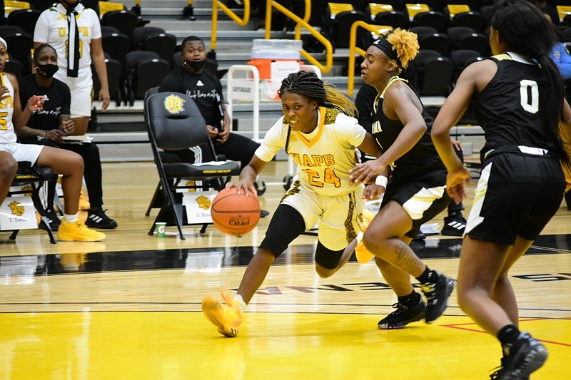 Kaila Walker of the University of Arkansas-Pine Bluff drives to the basket against Dakiyah Sanders of Alabama State in the fourth quarter on Saturday, Jan. 9, 2021, in Pine Bluff.
