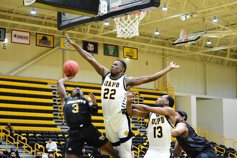 Omar Parchman (22) of the University of Arkansas at Pine Bluff tries to block the shot of D.J. Heath (3) of Alabama State on Saturday, Jan. 9, 2021, at Pine Bluff. Robert Boyd (13) is in on the play.