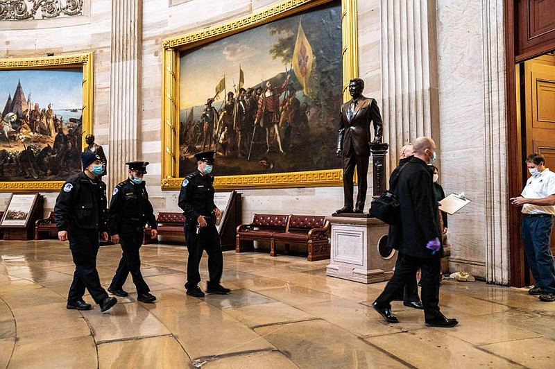 U.S. Capitol Police officers and investigators inspect the Capitol on Friday to log the destruction caused on Wednesday when rioters loyal to President Donald Trump overran the complex.
(The New York Times/Anna Moneymaker)