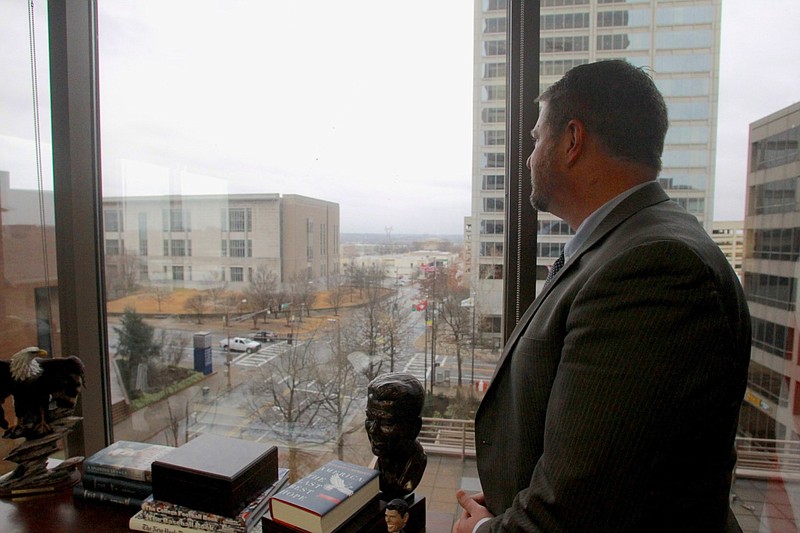 Acting U.S. Attorney Jonathan Ross looks out at the U.S. Federal Courthouse in downtown Little Rock from his vantage point on the fifth floor of the Simmons Bank Tower in this January 2021 file photo. Ross was appointed as U.S. attorney for the Eastern District of Arkansas after the resignation of U.S. Attorney Cody Hiland.