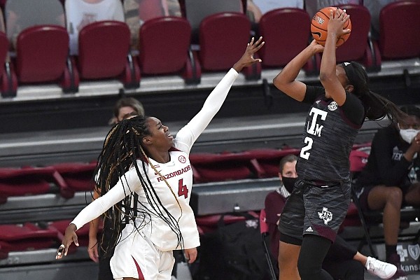 Arkansas’ Erynn Barnum tries to block a shot by Texas A&M’s Aaliyah Wilson on Sunday, Jan. 10, 2021, at Bud Walton Arena in Fayetteville. Arkansas lost 74-73. Visit nwaonline.com/210111Daily/ and nwadg.com/photos.
