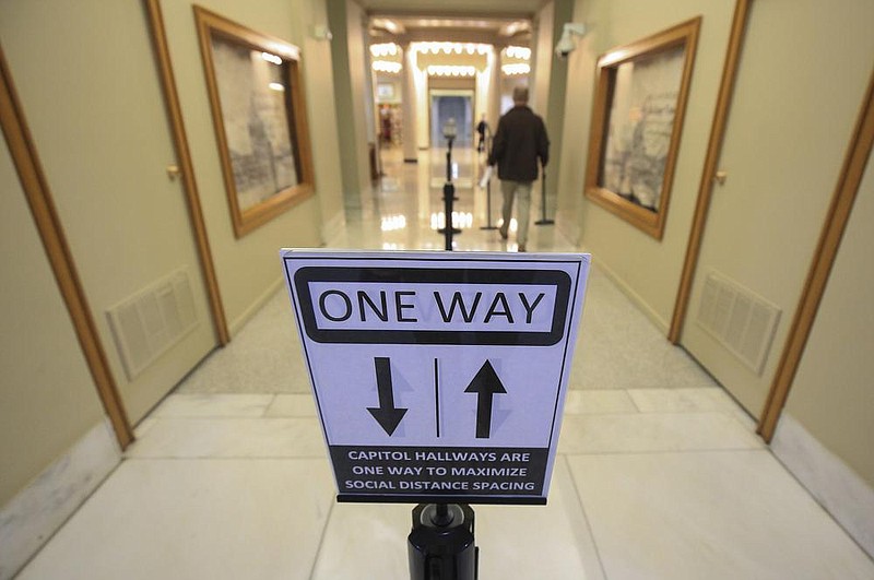 Signs in the hallways of the state Capitol inform visitors of social distancing rules. Arkansas’ 93rd General Assembly begins at noon Monday while coronavirus cases continue to soar.
(Arkansas Democrat-Gazette/Staton Breidenthal)