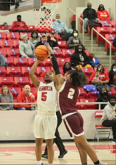 Magnolia junior Adrien Walker (5) has his shot blocked by Crossett’s Jaylon Brown during 4A-8 Conference action Friday night. The Panthers won 86-39 and will travel to Monticello on Tuesday.