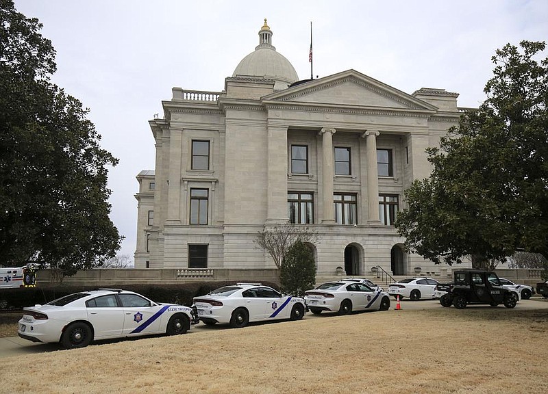 Arkansas State Police vehicles line the sidewalk on the south end of the state Capitol Monday Jan. 11, 2021 in Little Rock on the first day of the legislative session. 
(Arkansas Democrat-Gazette/Staton Breidenthal)