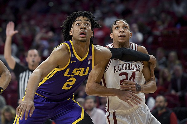 LSU's Trendon Watford (2) and Arkansas' Ethan Henderson (24) fight for position during the first half of an NCAA college basketball game Wednesday, March 4, 2020, in Fayetteville. (AP Photo/Michael Woods)
