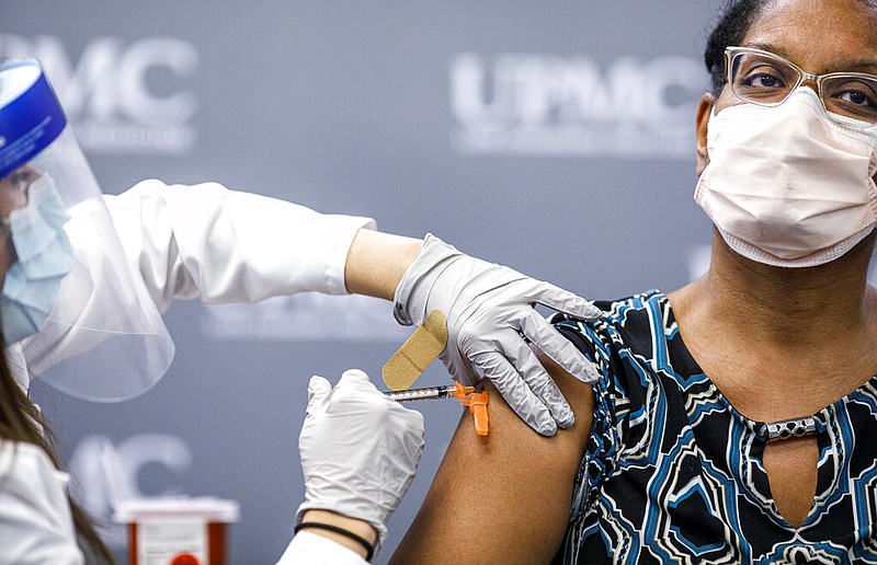 Jill Johnson adminsters the Pfizer covid-19 vaccine to Sharee Livingston, an OB-GYN with UPMC Lititz. UPMC frontline workers receive the first doses of the Pfizer covid-19 vaccine at UPMC Pinnacle Harrisburg hospital, December 18, 2020. story.lead_photo.caption