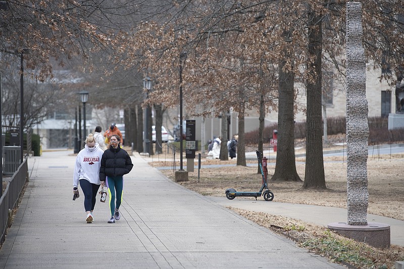 Erin Enmark (left) and Peyton Mosman walk back to their sorority house after going to the gym Monday Jan. 11, 2021 at the University of Arkansas campus in Fayetteville. Monday was the first day back to classes after the holiday break. Visit nwaonline.com/210112Daily/ and nwadg.com/photos. (NWA Democrat-Gazette/J.T. Wampler)