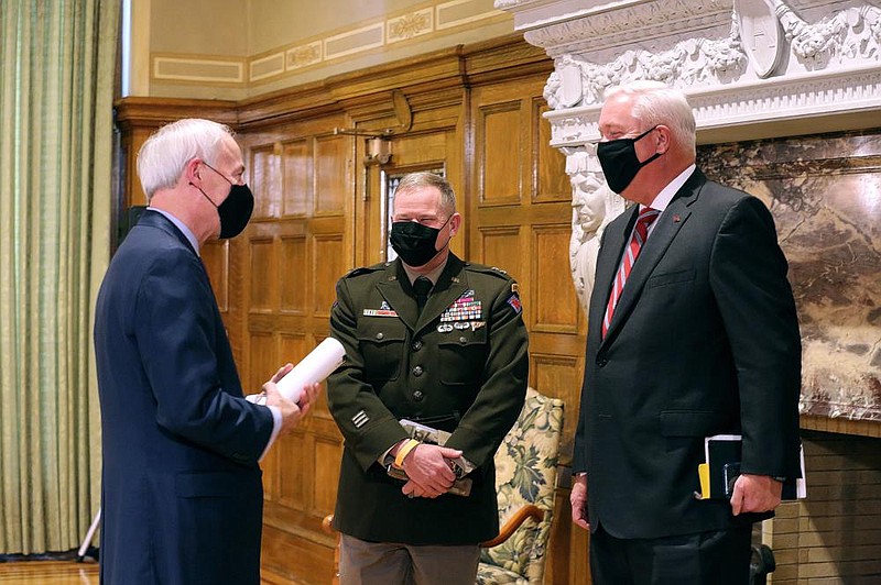 Gov. Asa Hutchinson (left) speaks with Major General Kendall Penn (center), Adjutant General of the Arkansas National Guard, and Retired Col. Robert Ator after the weekly covid-19 press conference on Tuesday, Jan. 12, 2021, at the state Capitol in Little Rock. 
(Arkansas Democrat-Gazette/Thomas Metthe)