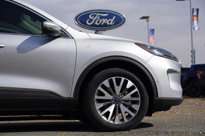 A 2020 Ford Escape SUV sits at a dealership in Denver in this file photo. Ford said its Louisville Assembly Plant in Kentucky, which builds the Escape along with the Lincoln Corsair, will be idled this week because of the semiconductor shortage.
(AP)
 