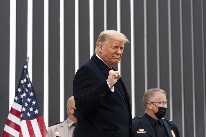 President Donald Trump pumps his fist as he tours a section of the U.S.-Mexico border wall, Tuesday, Jan. 12, 2021, in Alamo, Texas.