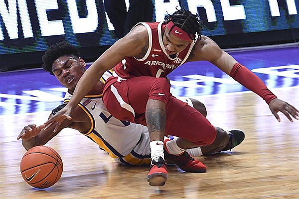 LSU forward Mwani Wilkinson, left, and Arkansas guard JD Notae (1) vie for the ball during the first half of an NCAA college basketball game Wednesday, Jan. 13, 2021, in Baton Rouge, La. (Hilary Scheinuk/The Advocate via AP)