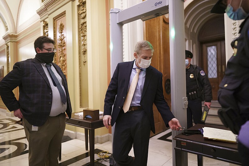Rep. Jim Jordan, R-Ohio, an ally of President Donald Trump, passes through a metal detector as he enters the House chamber, new security measures put into place after a mob loyal to Trump stormed the Capitol, in Washington, Tuesday, Jan. 12, 2021. story.lead_photo.caption