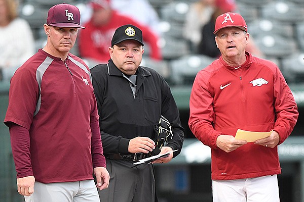 Arkansas-Little Rock coach Chris Curry (left), home plate umpire Jason Blackburn (center) and Arkansas coach Dave Van Horn are shown prior to a game Tuesday, April 2, 2019, in Fayetteville.