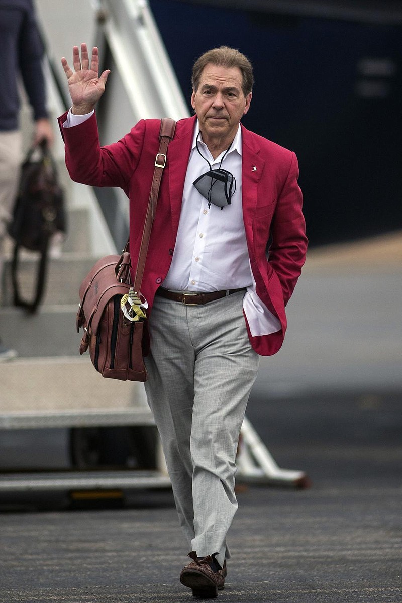 Alabama NCAA college football head coach Nick Saban waves as he walks toward cheering fans as the University of Alabama football team arrives home at the Tuscaloosa National Airport after winning the 2021 College Football Playoff national championship, Tuesday, Jan. 12, 2021, in Tuscaloosa, Ala. (AP Photo/Vasha Hunt) story.lead_photo.caption
