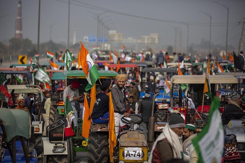 Farmers in Ghaziabad, outside New Delhi, hold a tractor rally last year to protest new farm laws in India. On Tuesday, India’s top court put a hold on implementing the new laws.
(AP)