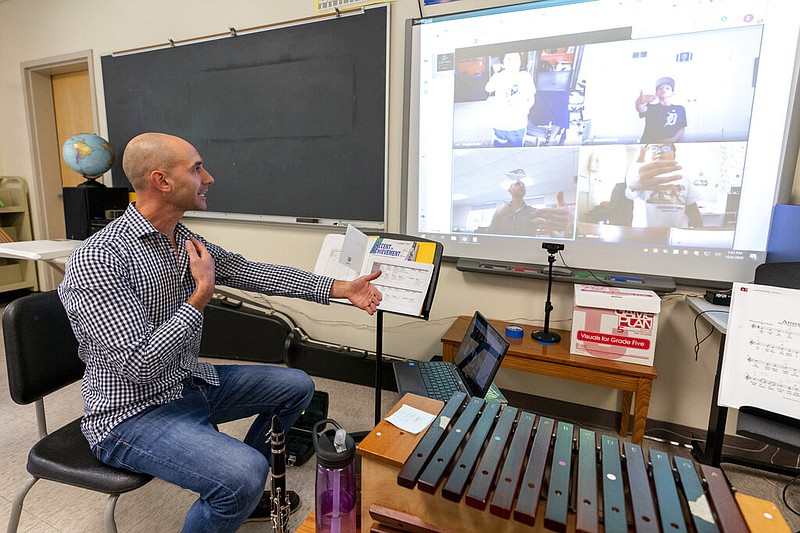 Eric DiVito gives breathing instructions as he teaches a remote music class at the Osborn School in Rye, N.Y., in this Oct. 6, 2020, file photo.