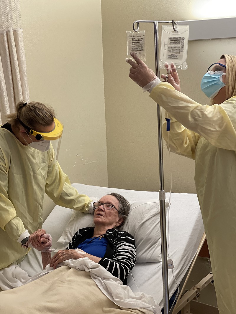 Alison Alderson, RN, and Karen McCullar, RN clinical nurse consultant, administer a monoclonal antibody infusion to a COVID patient at Courtyard. (Contributed)