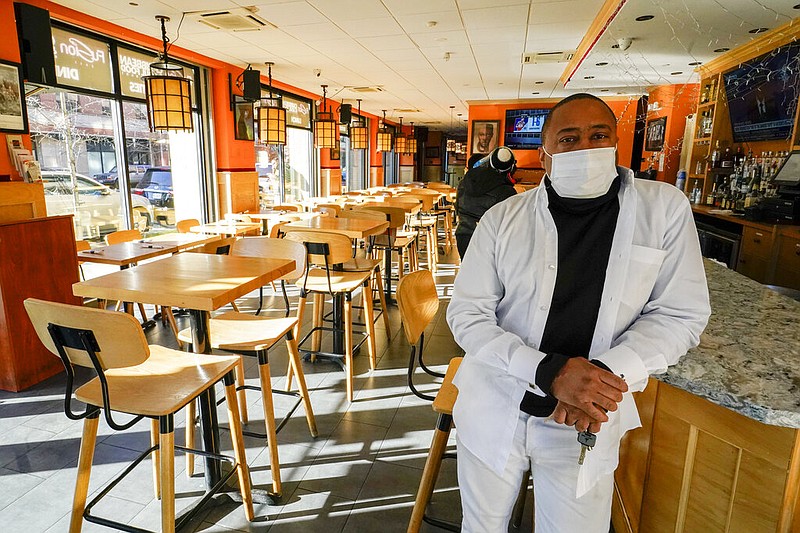 Andrew Walcott, owners of Fusion East Caribbean & Soul Food restaurant, poses for a photo at the restaurant in East New York neighborhood of the Brooklyn borough of New York, Thursday, Jan. 7, 2021.