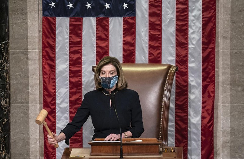 House Speaker Nancy Pelosi oversees the final impeachment vote Wednesday after declaring of President Donald Trump: “He must go, he is a clear and present danger to the nation that we all love.”
(AP/J. Scott Applewhite)